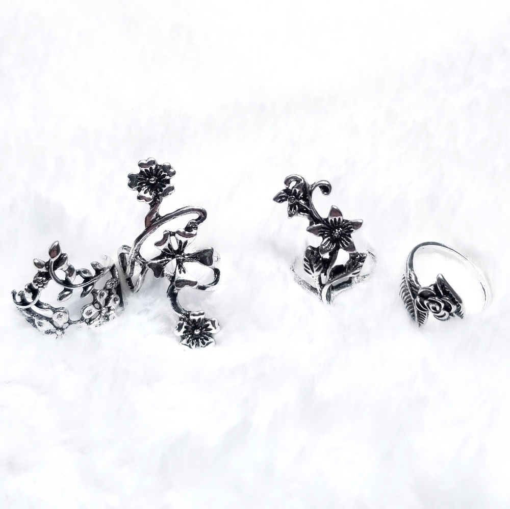 Four floral silver tone boho rings